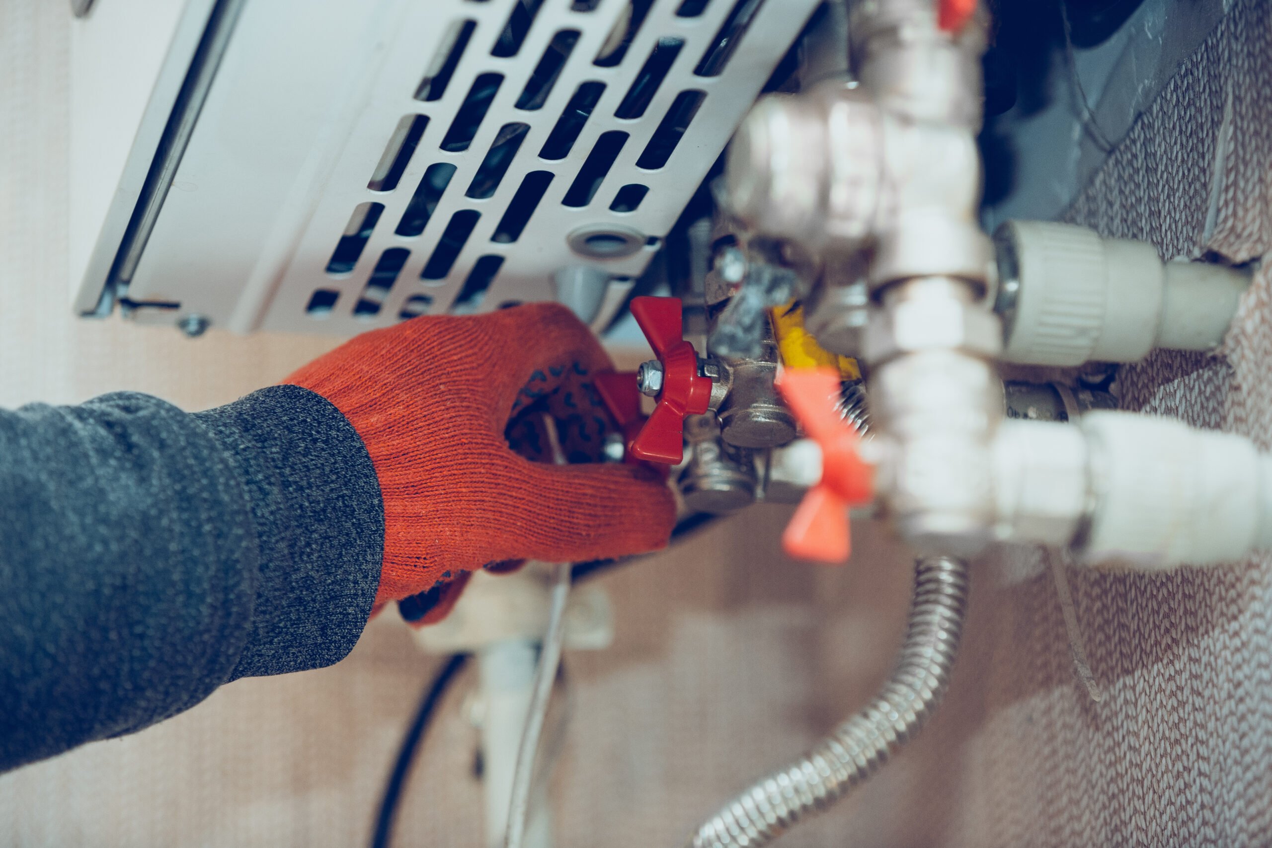 Male hand closes the wick of a gas bottle, heater, shuts off the flow